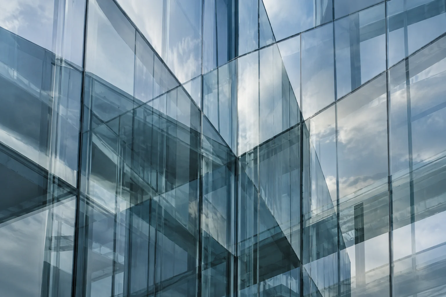 Layered glass curtain wall, overlapping reflections making the depth of the facade ambiguous.
